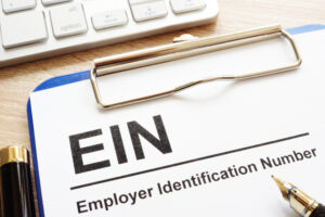 clipboard with "EIN" typed out on a piece of paper. 