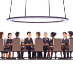 a board of directors gathered around a table holding an annual meeting