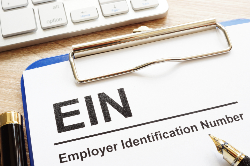 clipboard with "EIN" typed out on a piece of paper.