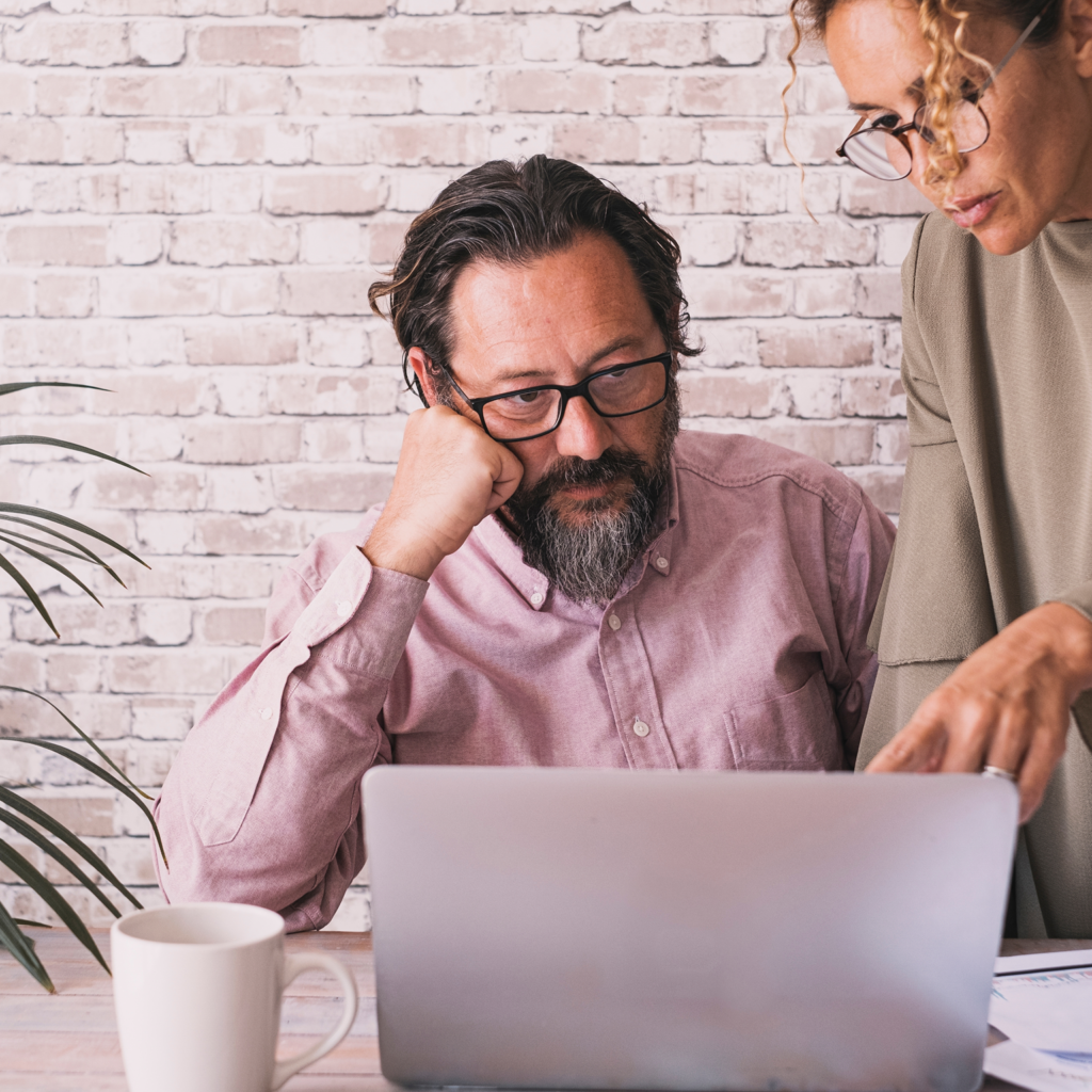 man and woman looking at a laptop